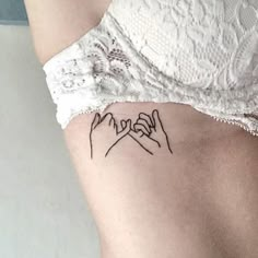 a woman's stomach with two hands holding the word love tattooed on her side