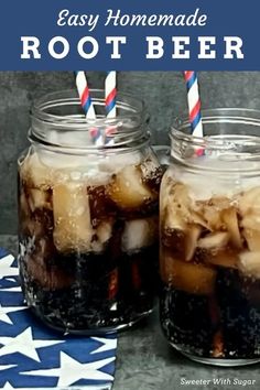 two mason jars filled with root beer on top of a blue and white table cloth