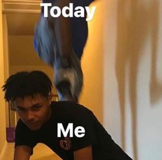 a man sitting on top of a wooden floor next to a wall with the words today me