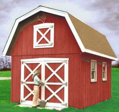 a man standing in front of a red barn with an open door on the side