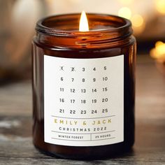 a candle is sitting on a table with a calendar sticker in front of it