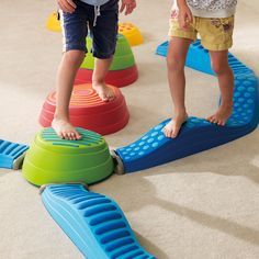 two young children playing with toys on the floor