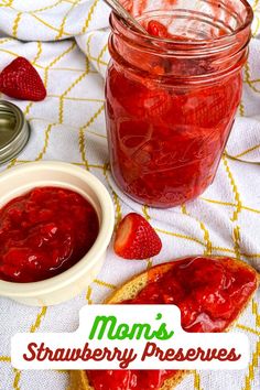 a jar of strawberry preserves next to a slice of bread