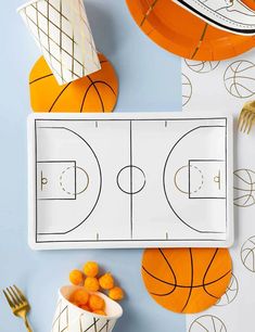 basketball themed party supplies including plates, forks and napkins