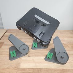 four pieces of electronic equipment sitting on top of a wooden table next to each other