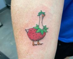 a duck with a strawberry on it's leg