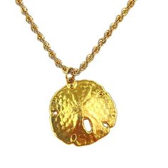 This vintage gold sand dollar pendant necklace exudes a charming beach-inspired aesthetic. The sand dollar charm adds a touch of nautical elegance, enhancing the boho chic vibe. Perfect for those who appreciate unique and timeless accessories, this necklace features an 18-inch rope chain that complements the gold pendant beautifully. * Vintage gold sand dollar pendant * 18-inch rope chain * Beach-inspired, nautical design * Boho chic style * Timeless and unique accessory N/A Size: 18", 1" pendant Gold Coastal Jewelry Gift, Gold Strand Jewelry For Gift, Coastal Style Gold Strand Jewelry, Gold Strand Necklace Ocean-inspired, Adjustable Gold Ocean-inspired Charm Necklace, Ocean-inspired Gold Necklaces For Vacation, Gold Strand Necklace With Ocean-inspired Style, Gold Ocean-inspired Strand Necklace, Ocean-inspired Gold Round Pendant Jewelry