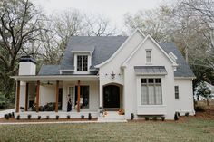 a white house with a black door and windows