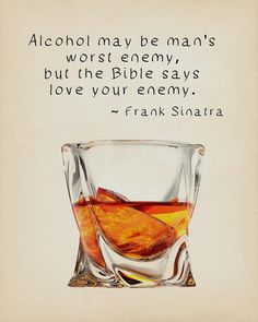 a glass filled with liquid sitting on top of a table next to a quote about alcohol