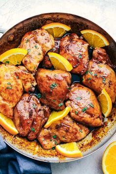 chicken thighs with lemons and herbs in a skillet