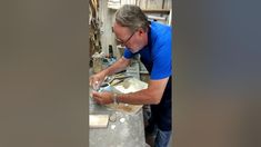 a man is working on something in a shop with woodworking tools and other items