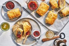 some food is laying out on the table with sauces and condiments around it