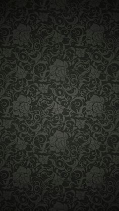 a black wallpaper with swirly designs on it