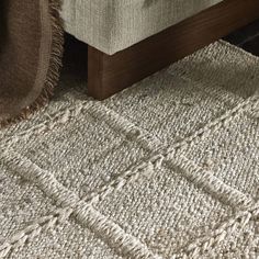 an upholstered bed with a wooden headboard and foot board on the floor