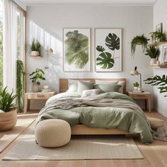 a bedroom with white walls and wooden flooring has plants on the wall above the bed