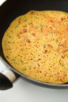 an omelet is cooking in a pan on the stove