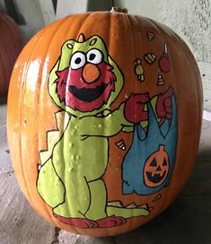 a sesame street pumpkin with an image of oscar and cookie monster painted on the front