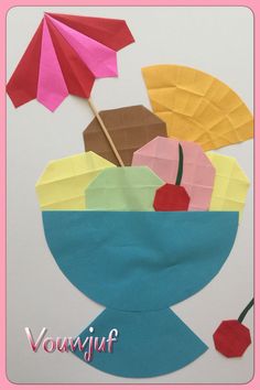 an origami cut out of paper with umbrellas and fruit in a bowl