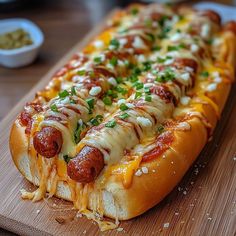 a long hot dog on a wooden cutting board