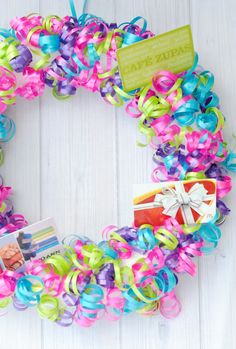 a wreath made out of colorful streamers and ribbons