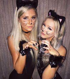 two women in cat costumes posing for the camera