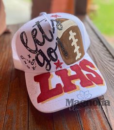 a hat with the word football on it sitting on top of a wooden table