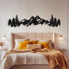 a bedroom with a large bed and mountains on the wall above it, along with two nightstands