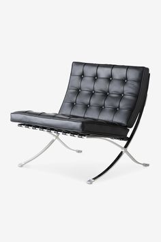 a black leather chair sitting on top of a metal frame legs and footrests