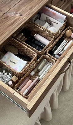 a wooden desk with drawers filled with pens, pencils and other office supplies in it