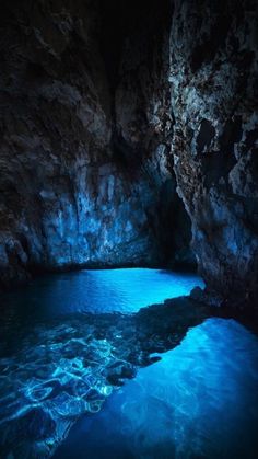 the water is blue in this cave and it looks like it's floating on top of