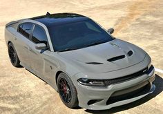 a gray dodge charger parked on top of a parking lot