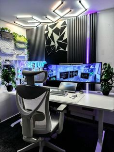 an office with two computer screens and a chair in front of the desk is illuminated by purple lights