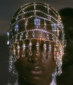 a woman wearing a suit and tie in front of a digital screen with rain drops on her head