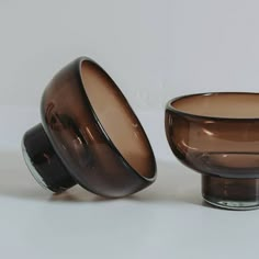 two brown glass bowls sitting next to each other