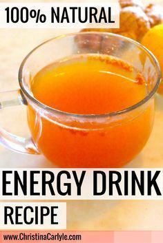 a glass mug filled with energy drink next to some cookies and oranges on a table