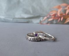 two silver rings sitting on top of a table