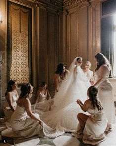 the bride is getting ready to walk down the aisle with her bridal party in white dresses