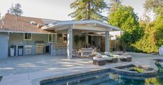 an outdoor living area with a pool and hot tub