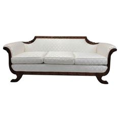 a white couch sitting on top of a wooden frame