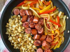 sausages, onions and peppers in a skillet