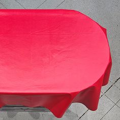 a red table cloth on top of a metal stand