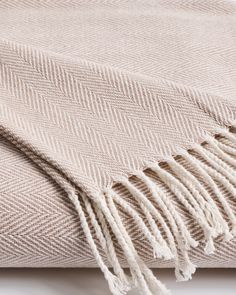 a blanket with fringes on top of it