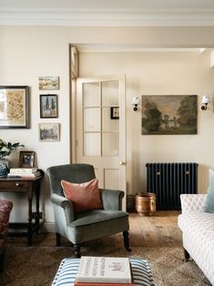 a living room filled with furniture and pictures on the wall