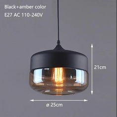 an image of a black and amber colored light fixture with measurements for the bulb size