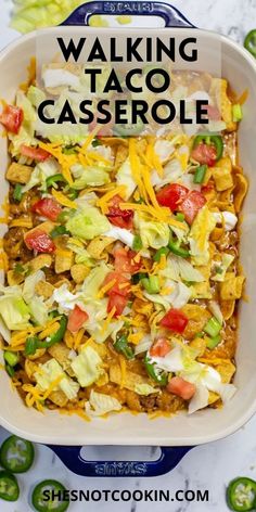 a casserole dish with cheese, lettuce and tomatoes in it is shown