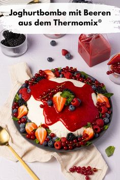 the cake is decorated with berries and raspberries