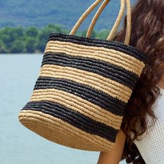 Elevate your summer style with BeauToday Women's Raffia Tote Bags. Crafted from natural raffia grass, each bag is handmade with love and features classic striped elements. With a large capacity, these bags are perfect for all your daily essentials and add a touch of African flair to your look. Main Material: Natural Raffia Bag Strap: Natural Raffia Strap Circumference: 44 cm Pattern Type: Streaks Closure Type: No Closure Size: 26 cm*26 cm*31 cm Weight: 0.514 kg Everyday Striped Straw Bag, Striped Woven Bags For Shopping, Striped Woven Tote Bag, Striped Woven Shopping Bags, Woven Striped Shopping Bags, Casual Striped Woven Bag, Striped Woven Straw Bag, Striped Rectangular Bag With Braided Handles, Casual Striped Woven Straw Bag