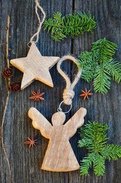 an ornament made out of wood with stars and fir branches on the table