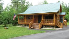 a log cabin sits on the side of a road