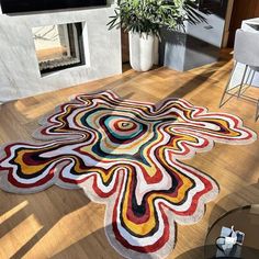 a living room with a large rug on the floor